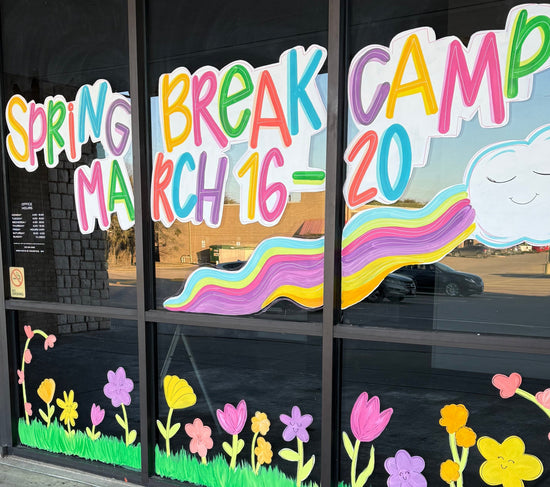 Business window display painted with colorful text and graphics for advertising 